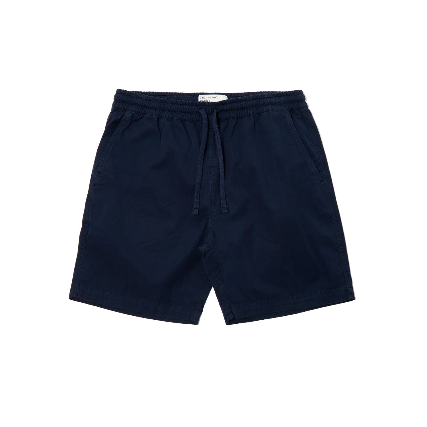 Beach Short - Summer Canvas NAVY
A high-quality mid-weight canvas, durable and tightly woven for a perfect crisp summer cotton fabric.
 
• Product Code: 28535.
• Elasticated waist with cord.
• No fly.
• Two front pockets.
• Single rear button-flap patch pocket.
• Tape detail.
• Fabric Content: 100% Cotton, 100% Cotton Trim.
• Washcare: Wash at 30 degrees. Do not bleach. Do not tumble dry. Warm iron. Do not dry clean. Wash like colours together. UNIVERSAL WORKS
