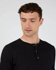 Henley T-Shirt BLACK
This is the contemporary British take on the classic Henley T-shirt. Made in Sunspots ultra-light long staple Supima cotton – the same fabric as the classic T-shirts – it has a wider rib cuff and refined trocas button placket, both taken from pieces in the archive. The fit is regular.
Henley shirts were traditional English 19th century rowing shirts, reminiscent of early Sunspel shirts, given a new lease of life in the late 20th century. This is a classic understated version. SUNSPEL